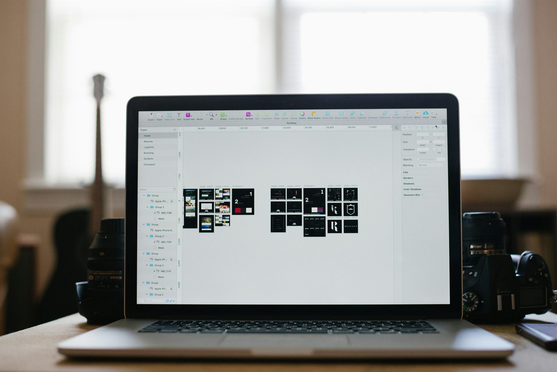 Laptop open in an editing tool with camera gear nearby