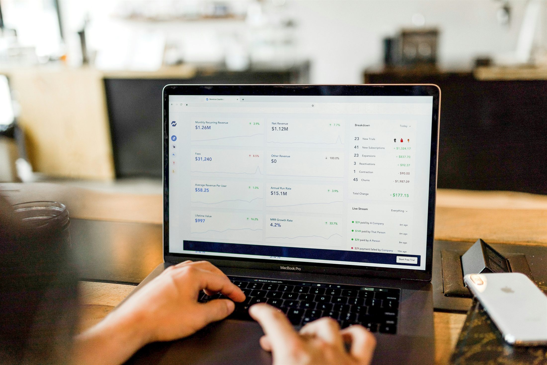 Laptop showing a revenue dashboard with a live payments feed